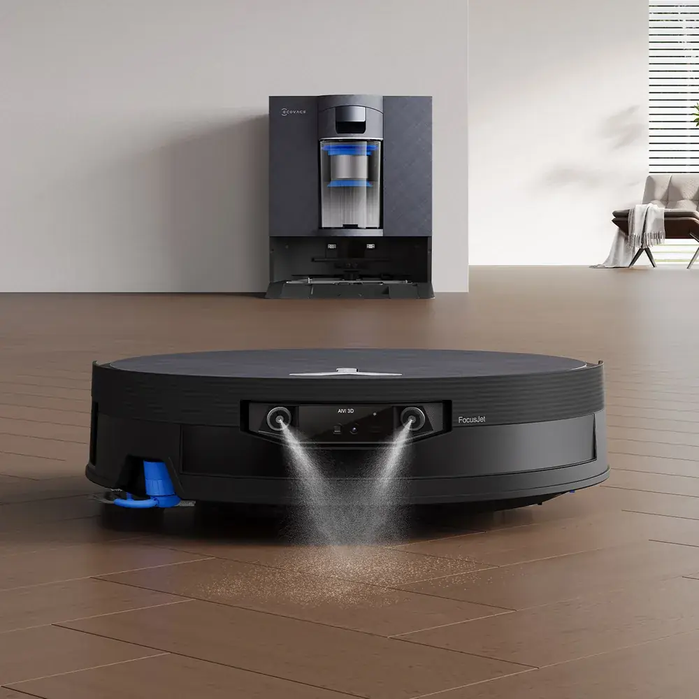 Ecovacs Deebot X12 OmniCyclone on a wood floor spraying ahead, with its dock against the wall behind (Ecovacs company image)