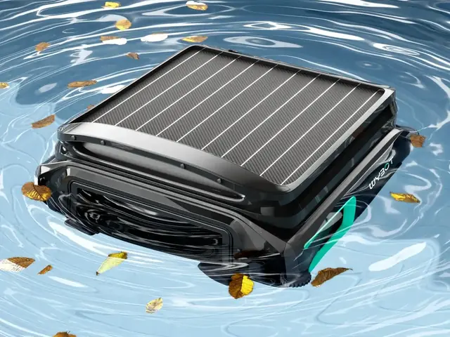 WYBOT F1 solar skimmer floating on a pool with leaves on the surface